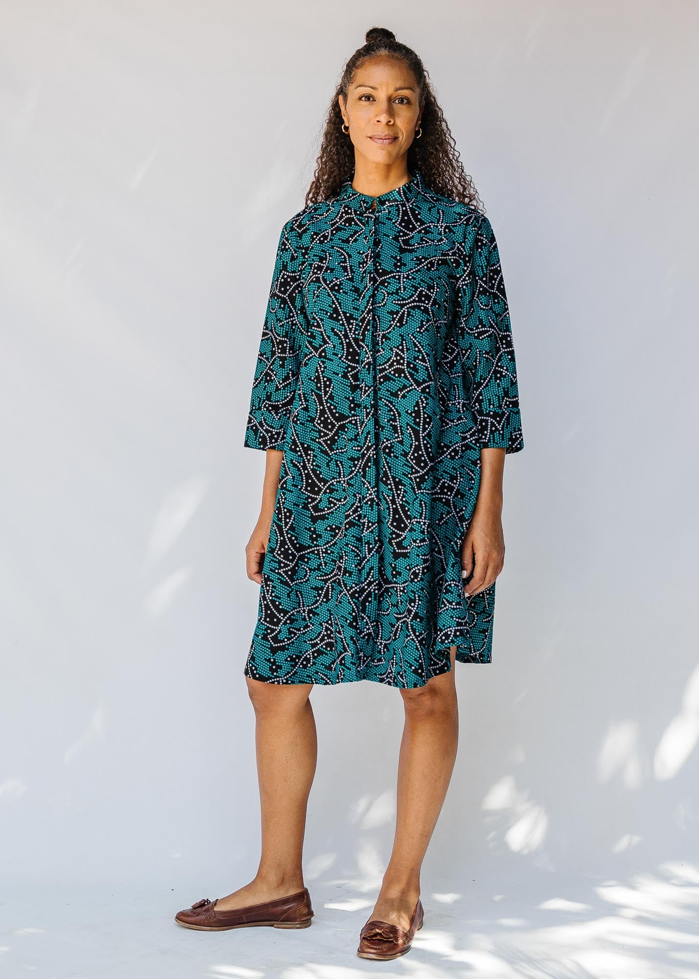 model wearing teal printed dress 