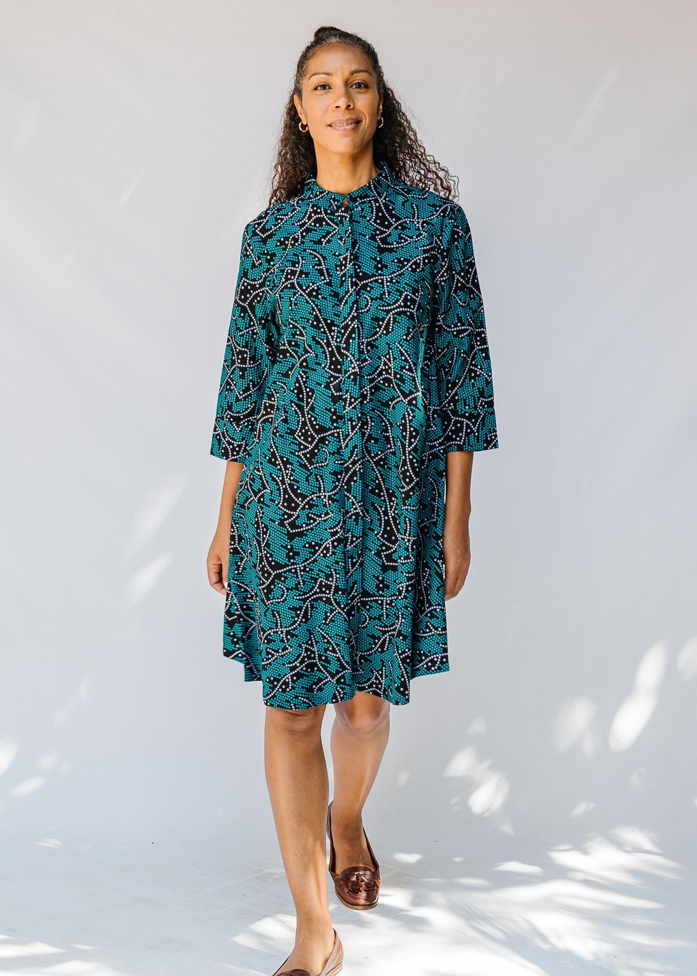 model wearing teal printed dress 