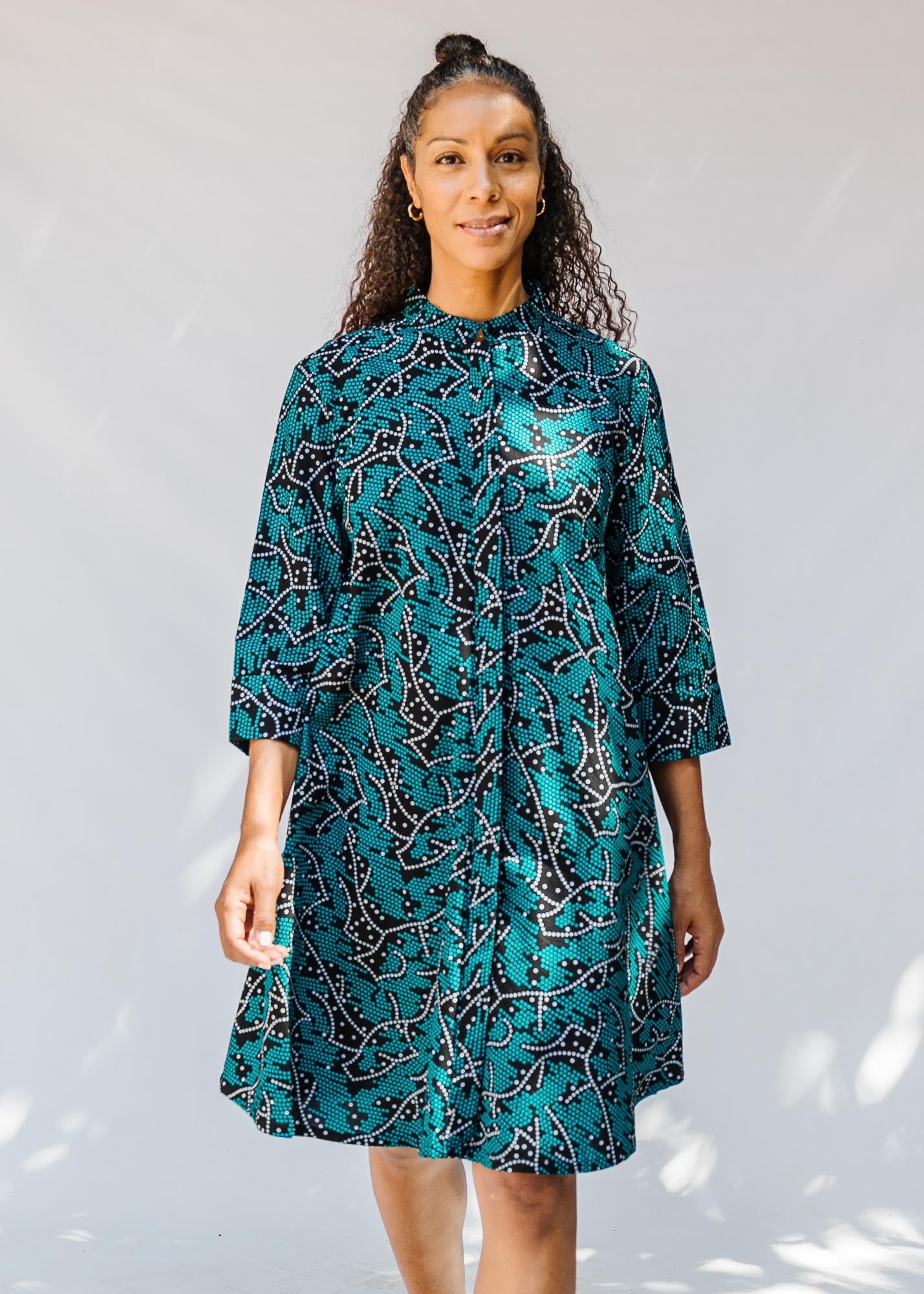 model wearing teal printed dress 