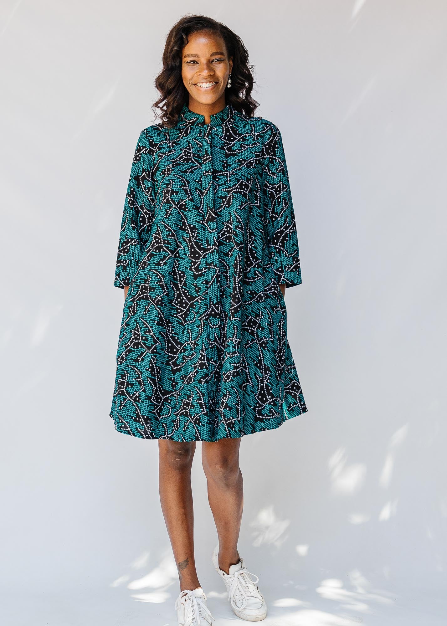 model wearing teal printed shirt dress