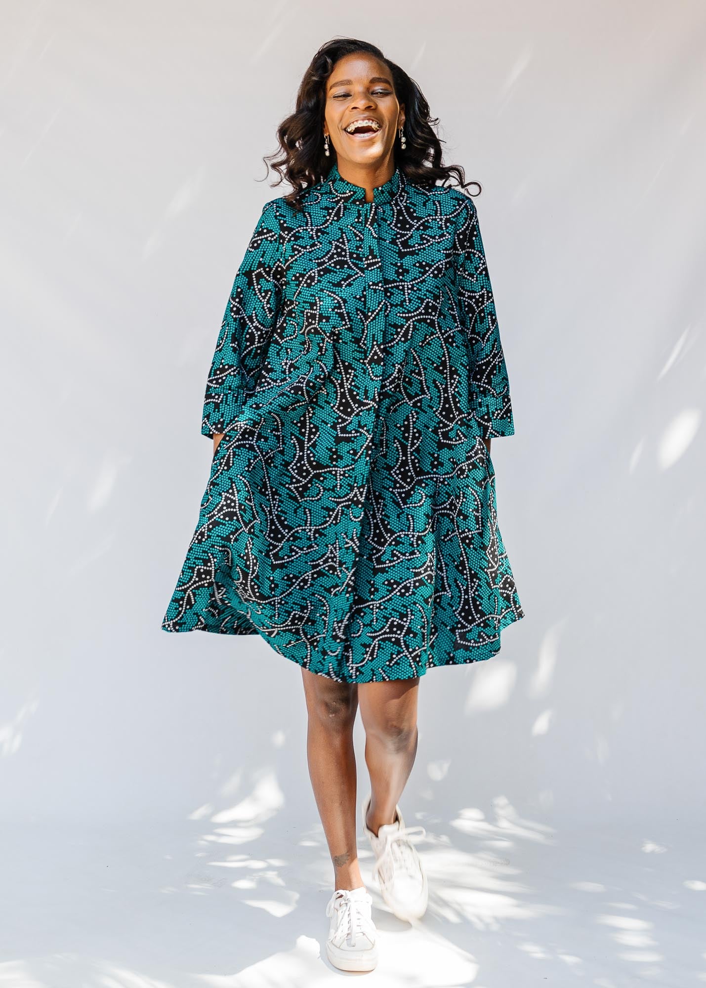 model wearing teal printed dress 