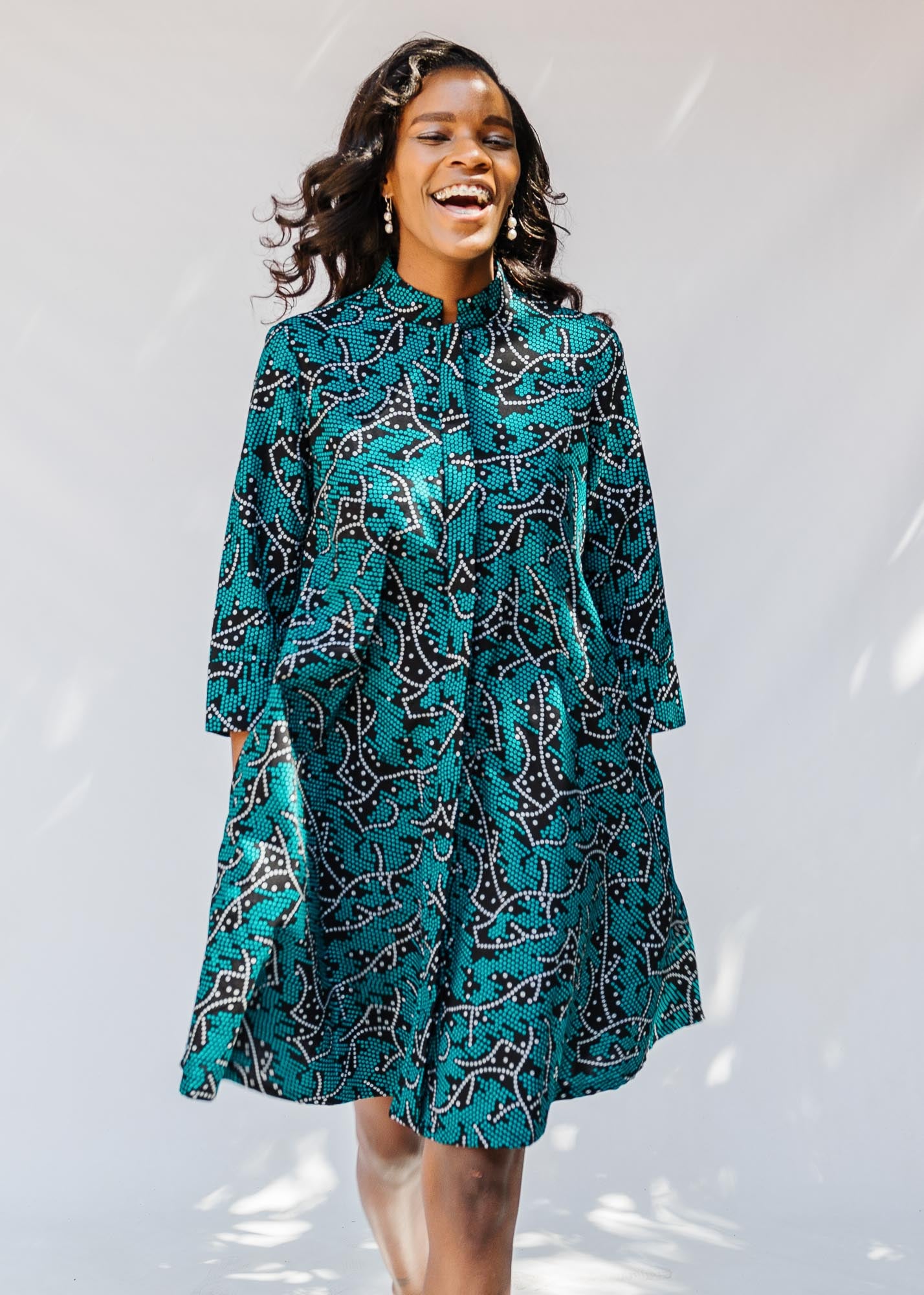 model wearing teal printed dress