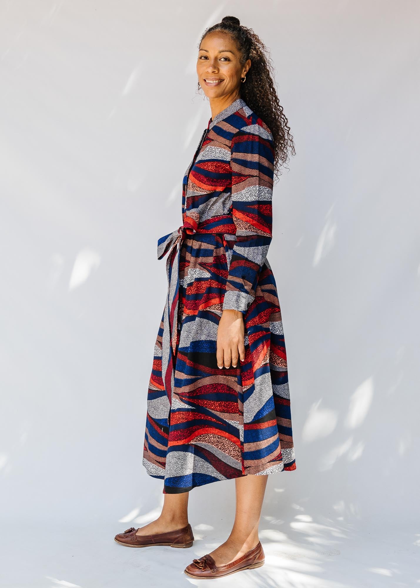 model wearing midi - length belted print dress