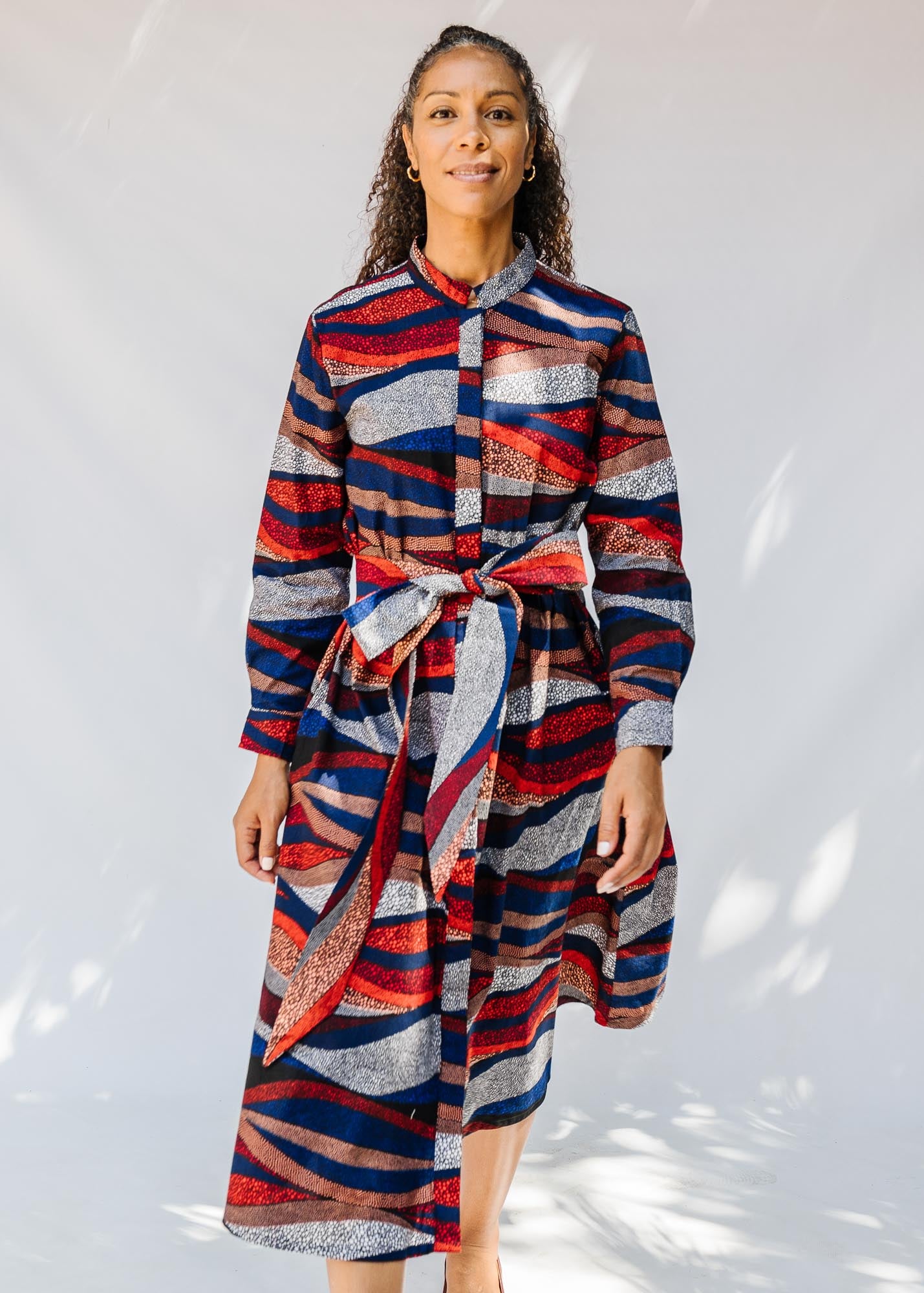 model wearing midi - length belted print dress