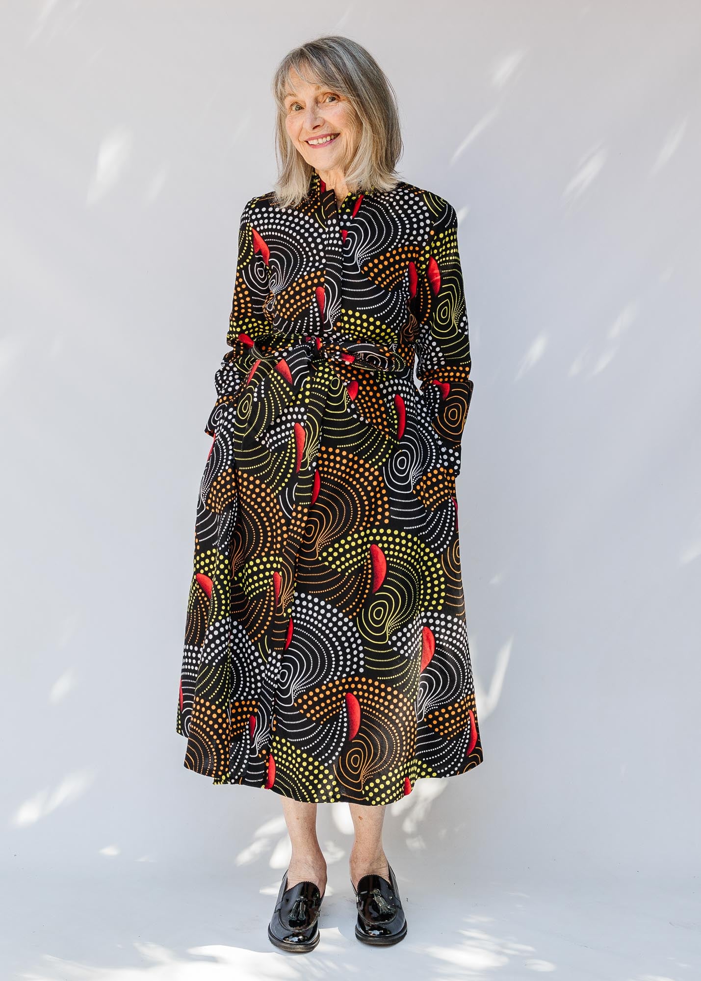 model wearing abstract geometric midi-length belted dress