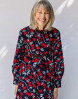 model wearing a red and navy belted midi-length dress