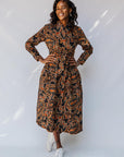 model wearing a midi-length belted paisley dress