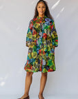 model wearing a multicolor leaf design dress