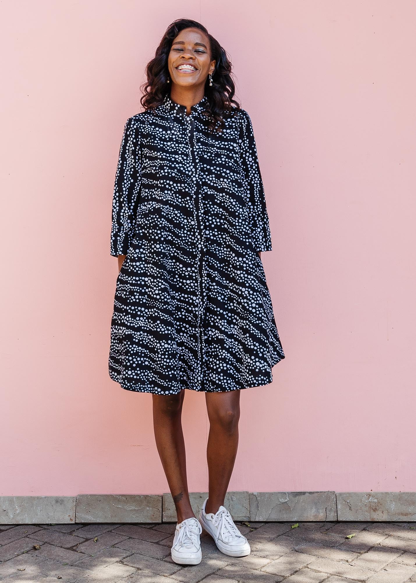 model wearing a black and white dress