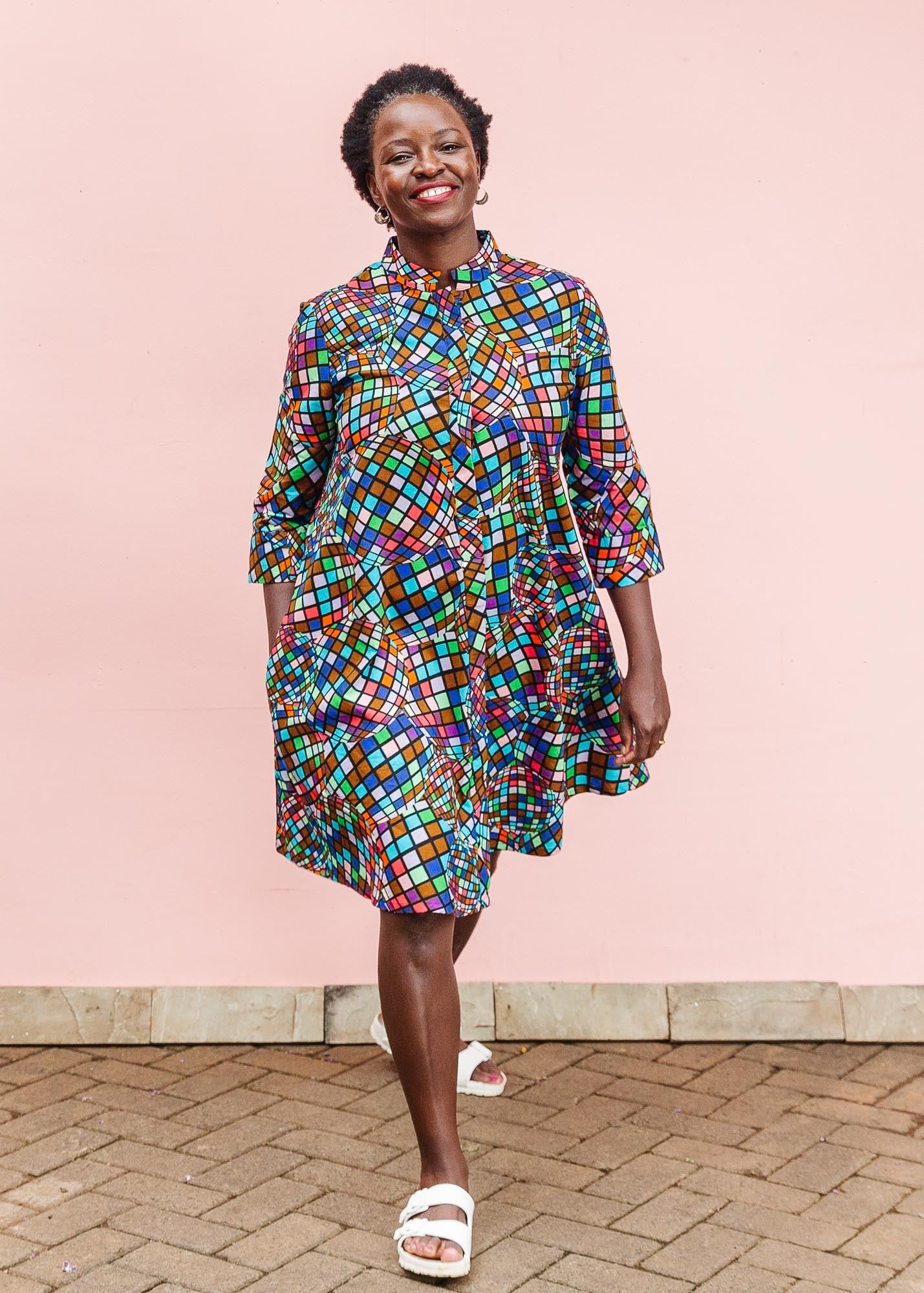 The model is wearing multi colored dress with disco ball print