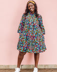 The model is wearing multi colored dress with disco ball print