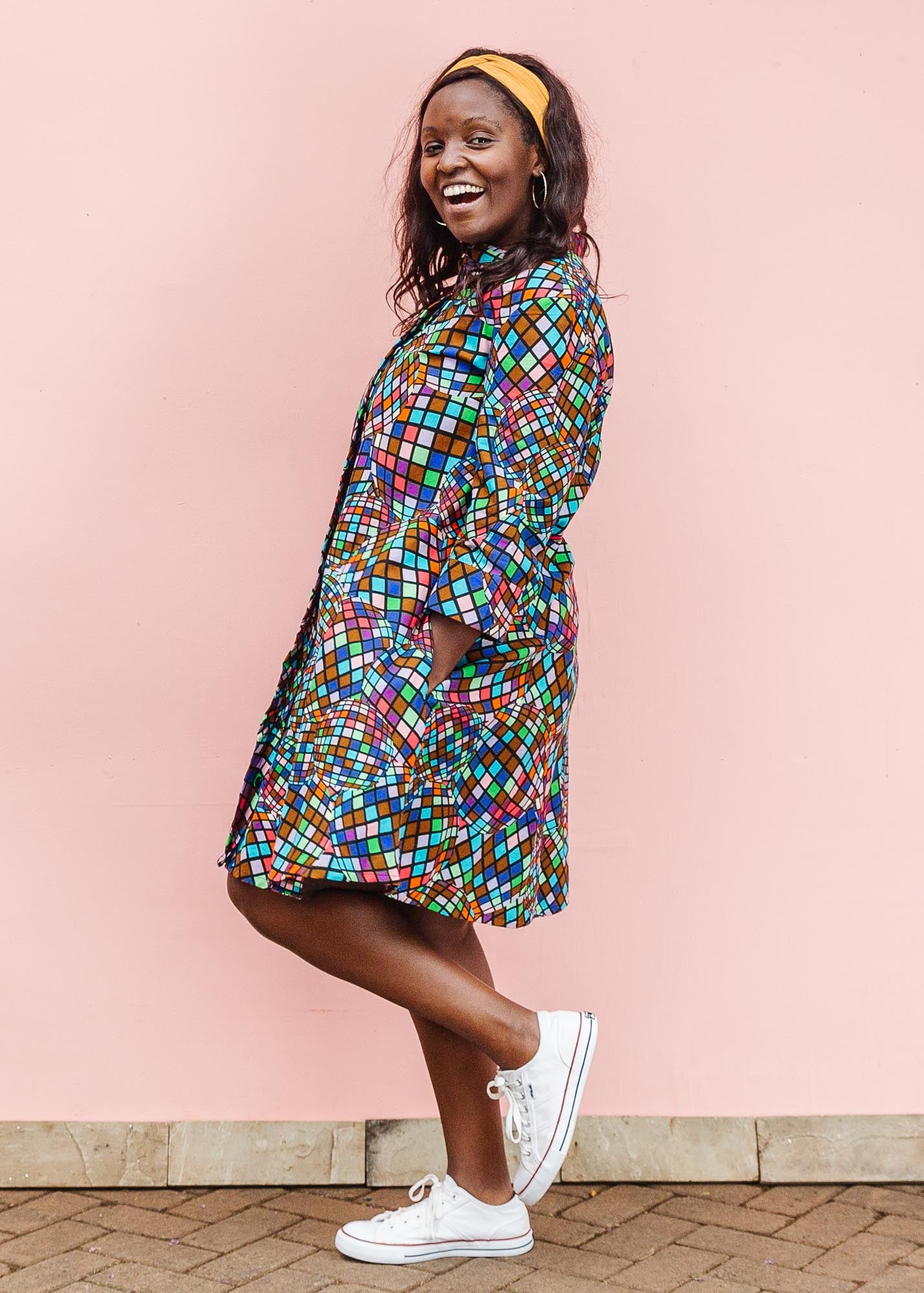 The model is wearing multi colored dress with disco ball print