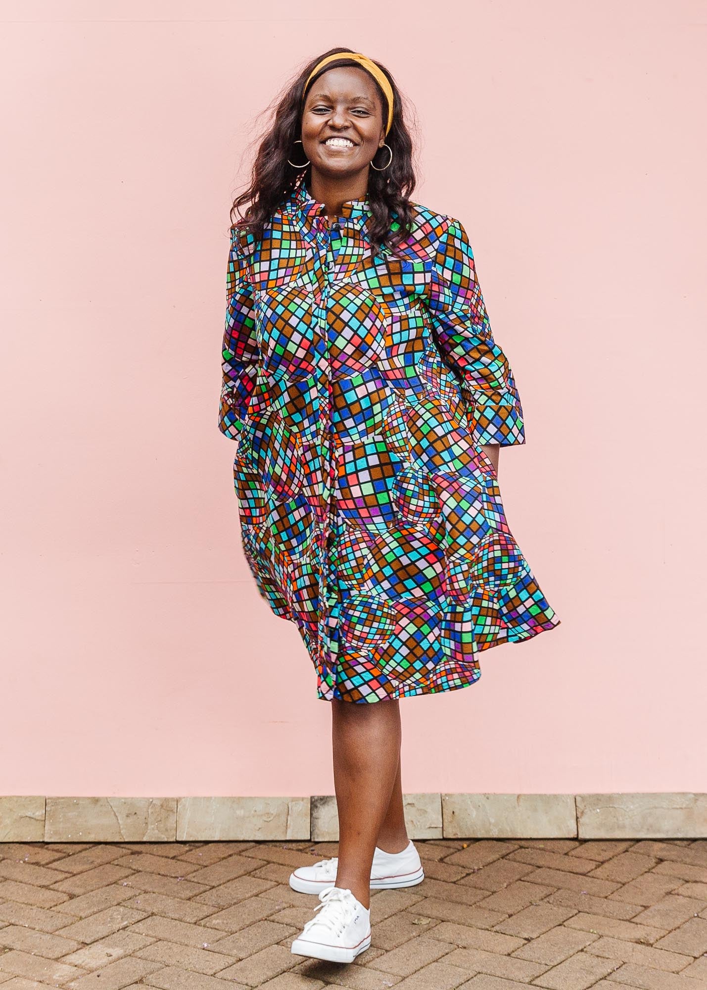 The model is wearing multi colored dress with disco ball print