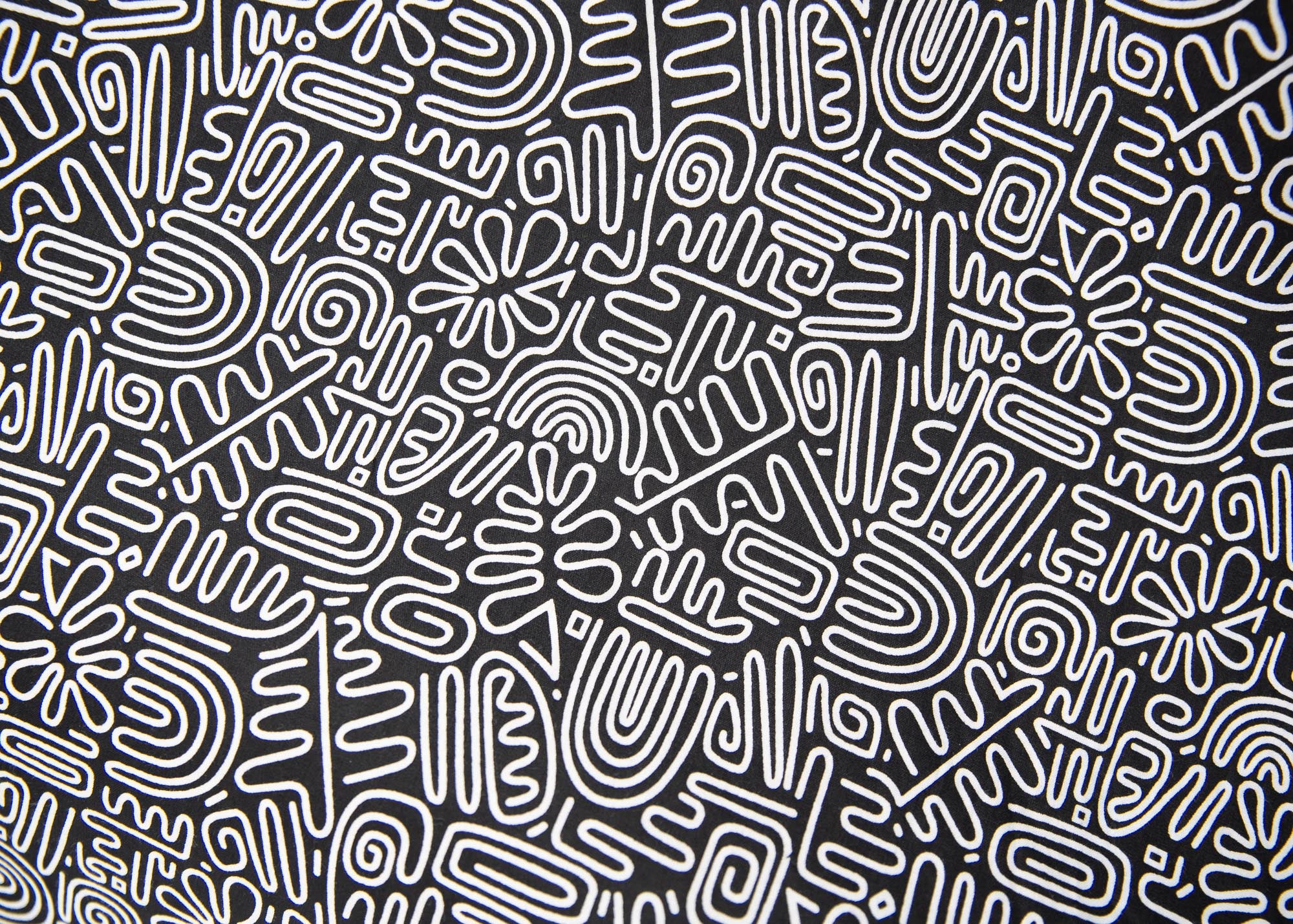 Close up display of black and white doodle print dress