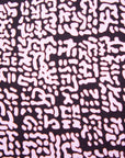 Close up display of brown and baby pink abstract print dress