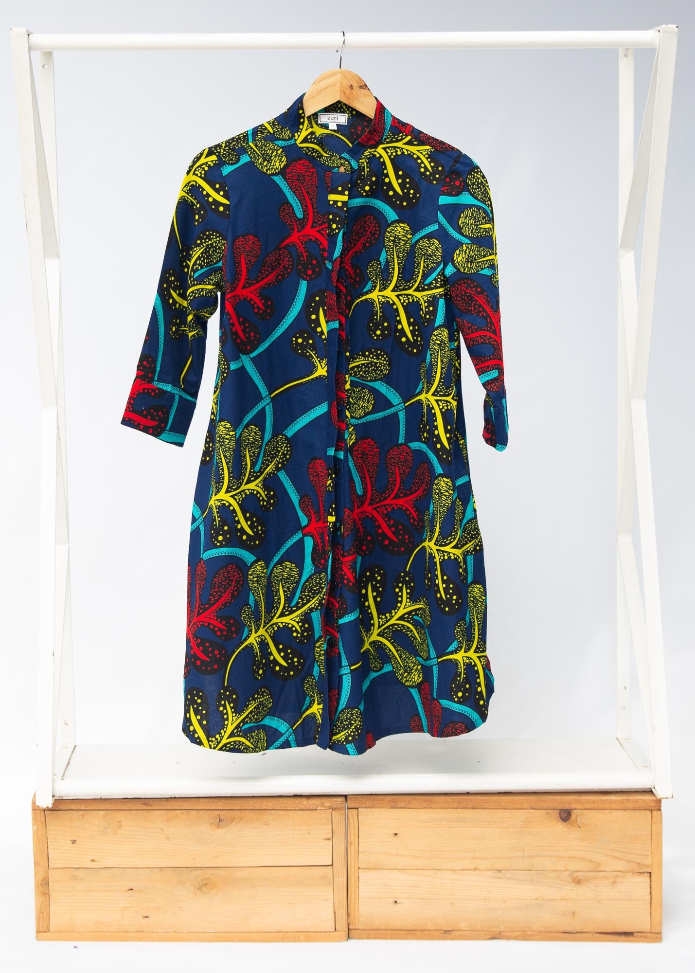 Display of blue, red, yellow, black and aqua vine print dress