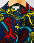 Display of blue, red, yellow, black and aqua vine print dress