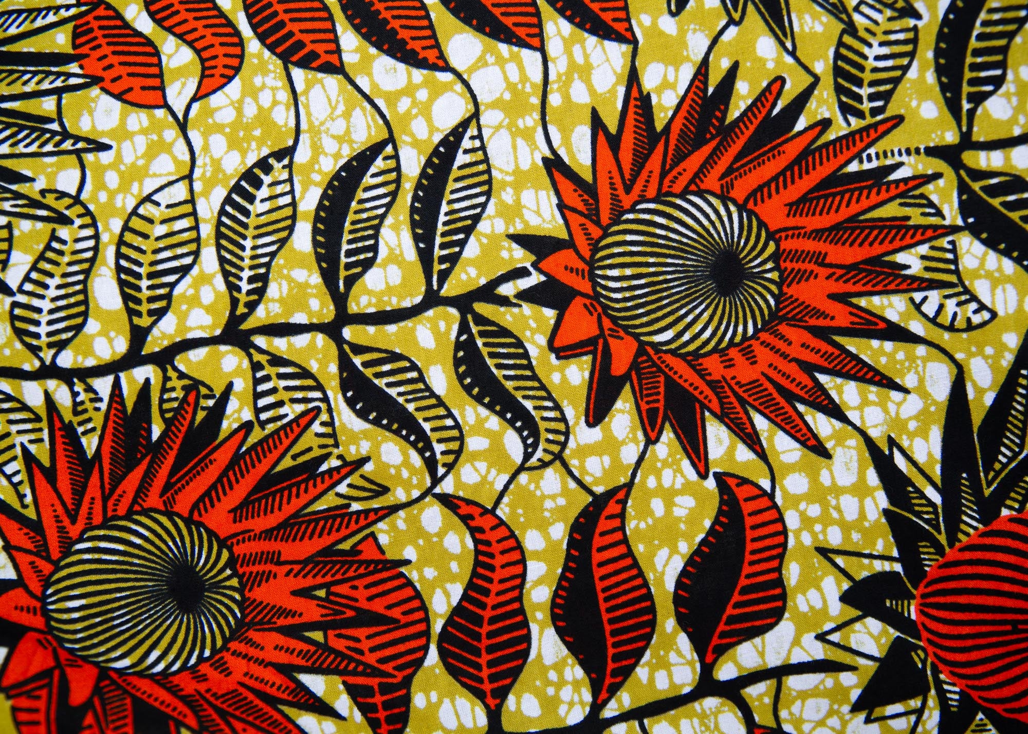 Close up display of white and chartreuse dress with orange and black sunflowers