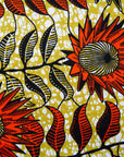 Close up display of white and chartreuse dress with orange and black sunflowers