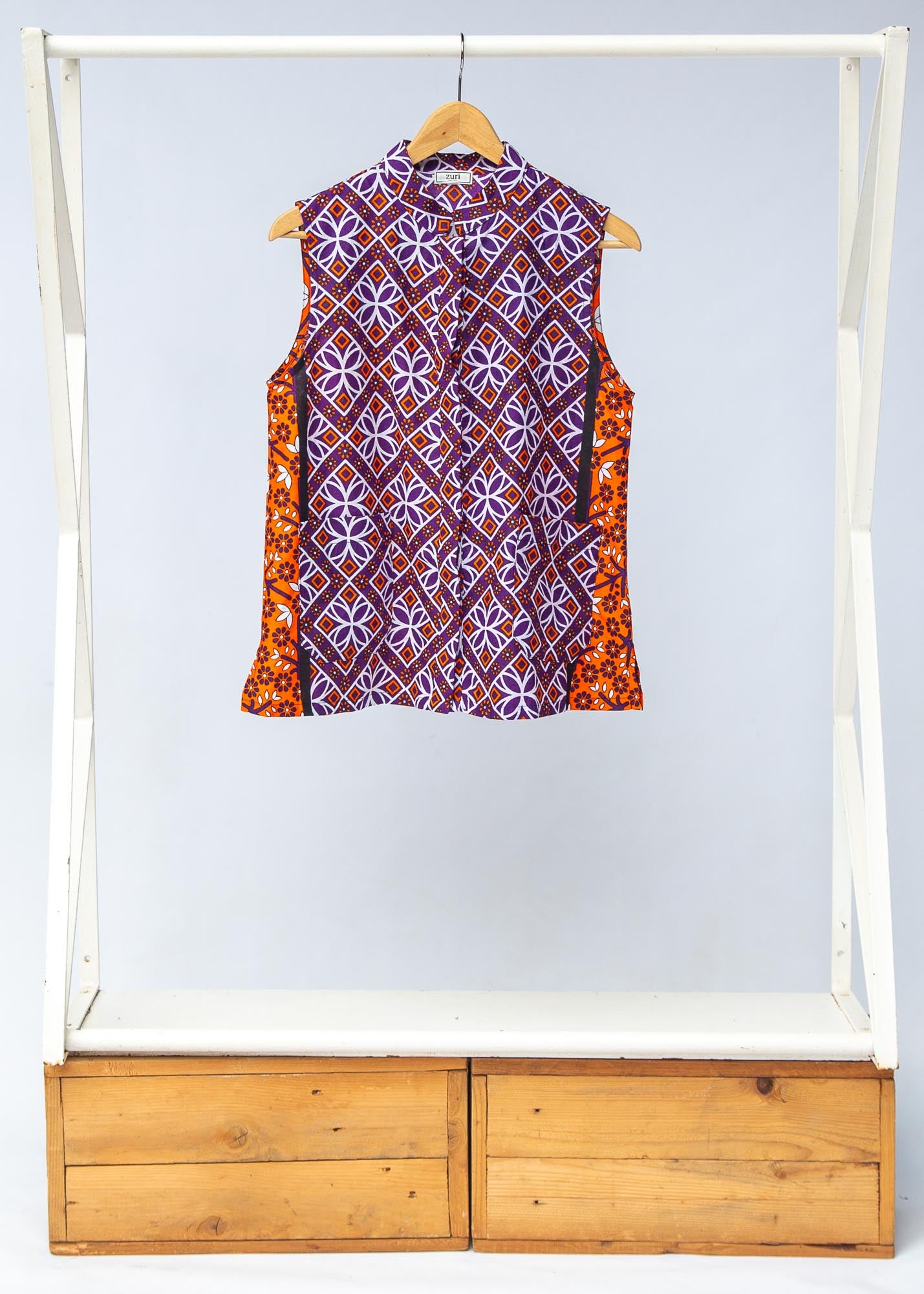 Display of orange, purple, white and black mixed pattern kanga tank