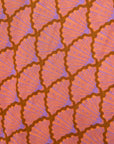 Close up display of peach-pink, lavender and brown seashell print dress