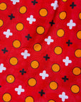 Close up display of red, white, black and orange mixed pattern long sleeved kanga shirt