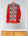 Display of red, white, black and orange mixed pattern long sleeved kanga shirt