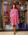 The model is wearing violet dress with red and white cabbages