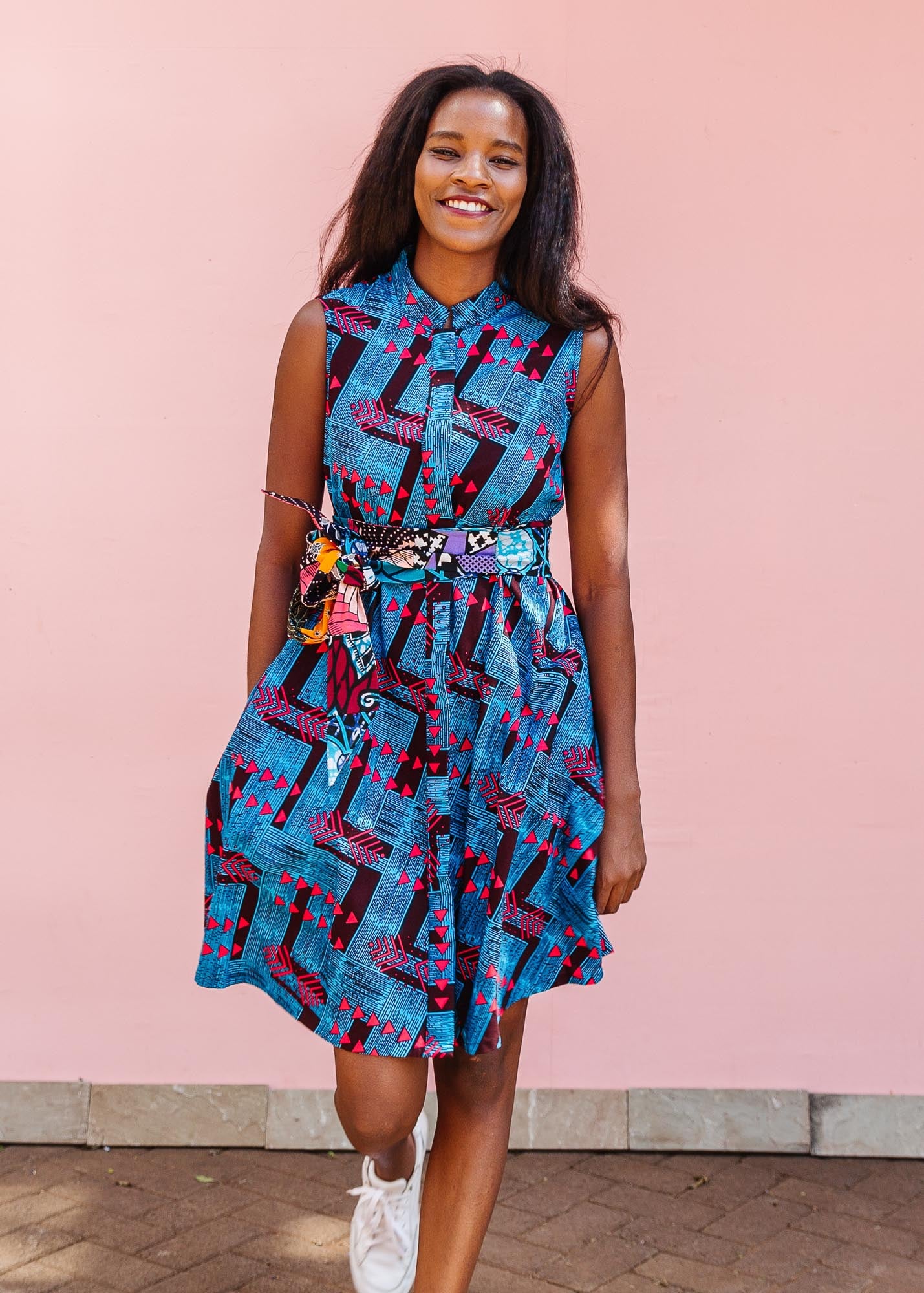 The model is wearing black, blue and hot pink geometric print dress