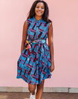 The model is wearing black, blue and hot pink geometric print dress