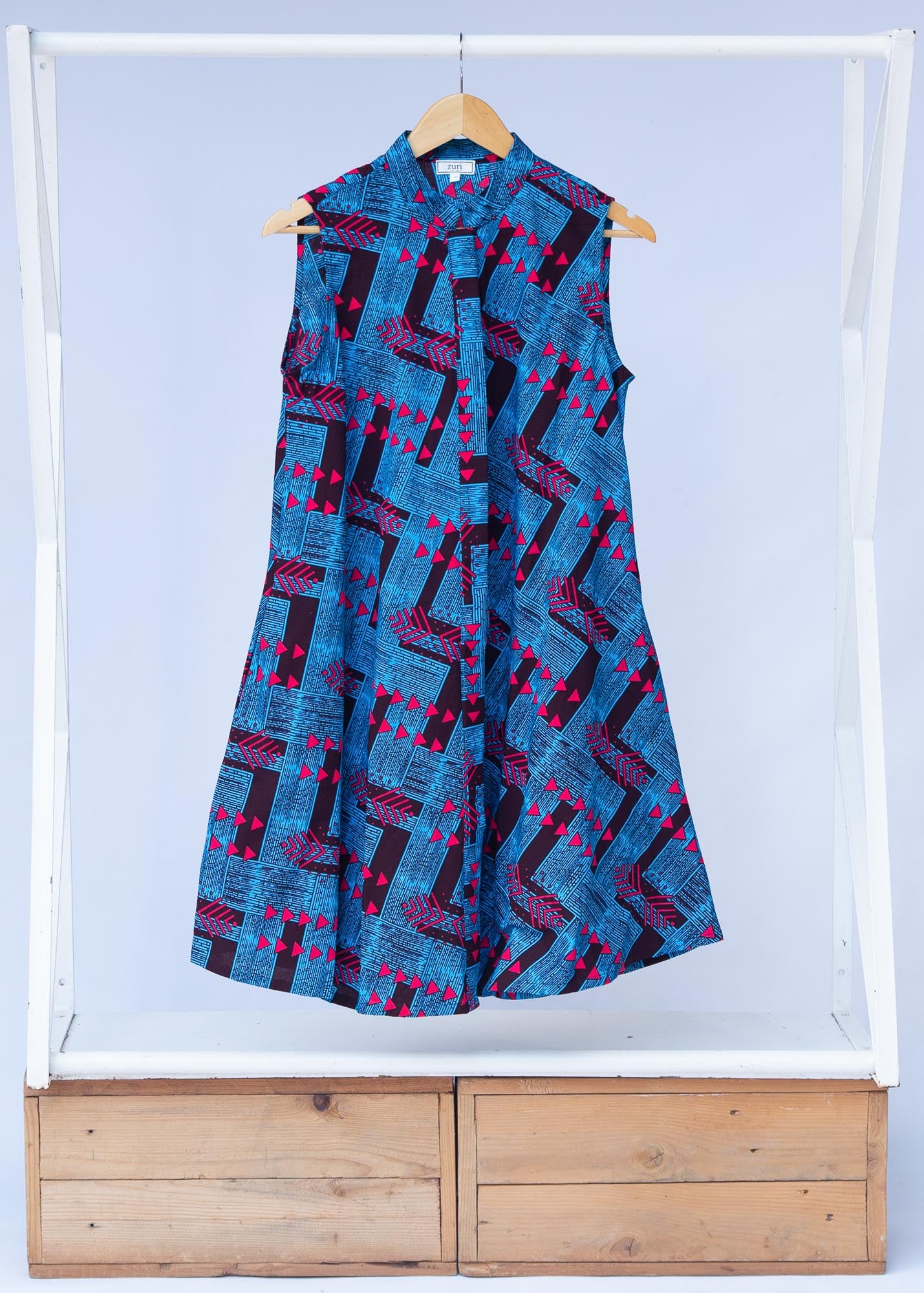 Display of black, blue and hot pink geometric print dress