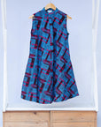 Display of black, blue and hot pink geometric print dress