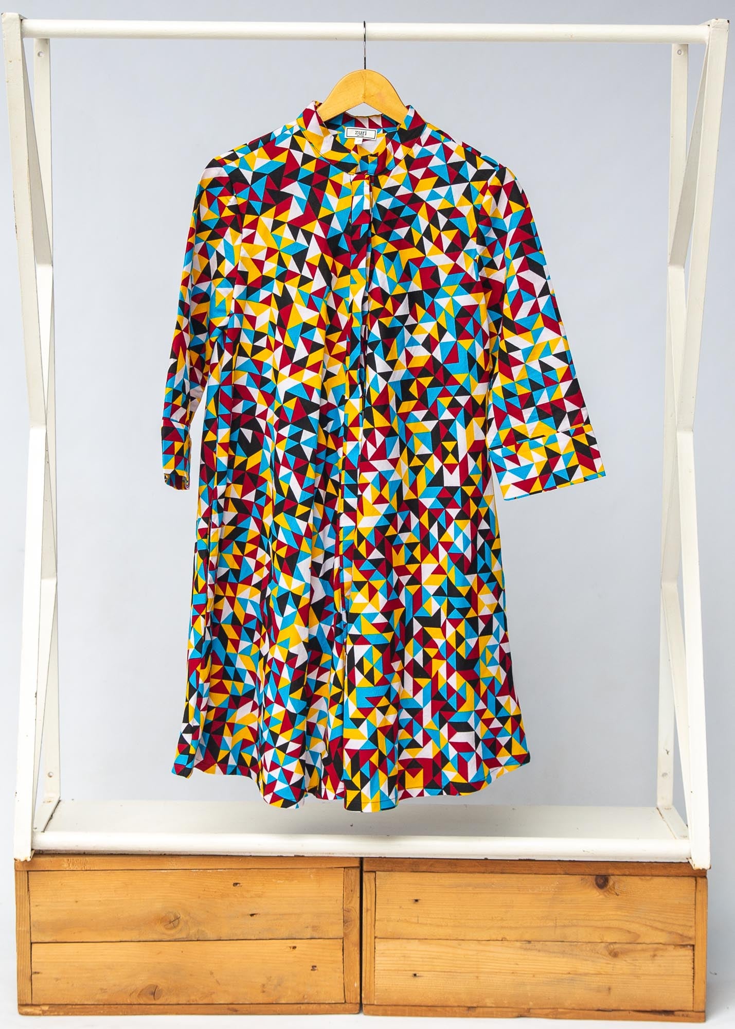 Display of multi colored geometric print dress