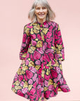 The model is wearing black, white, yellow, brown, pink, hot pink and purple bubble print dress