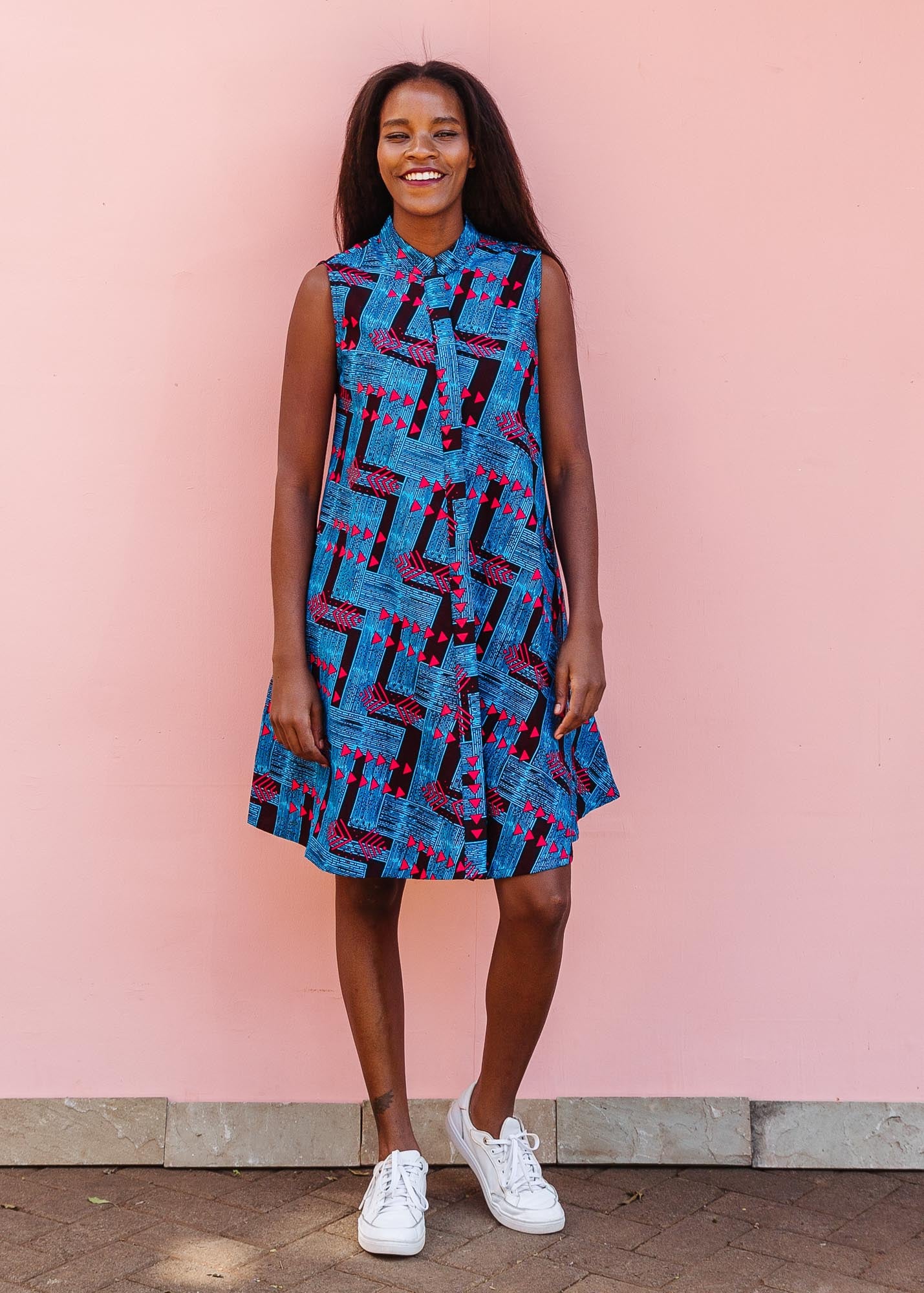 The model is wearing black, blue and hot pink geometric print dress