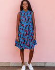 The model is wearing black, blue and hot pink geometric print dress