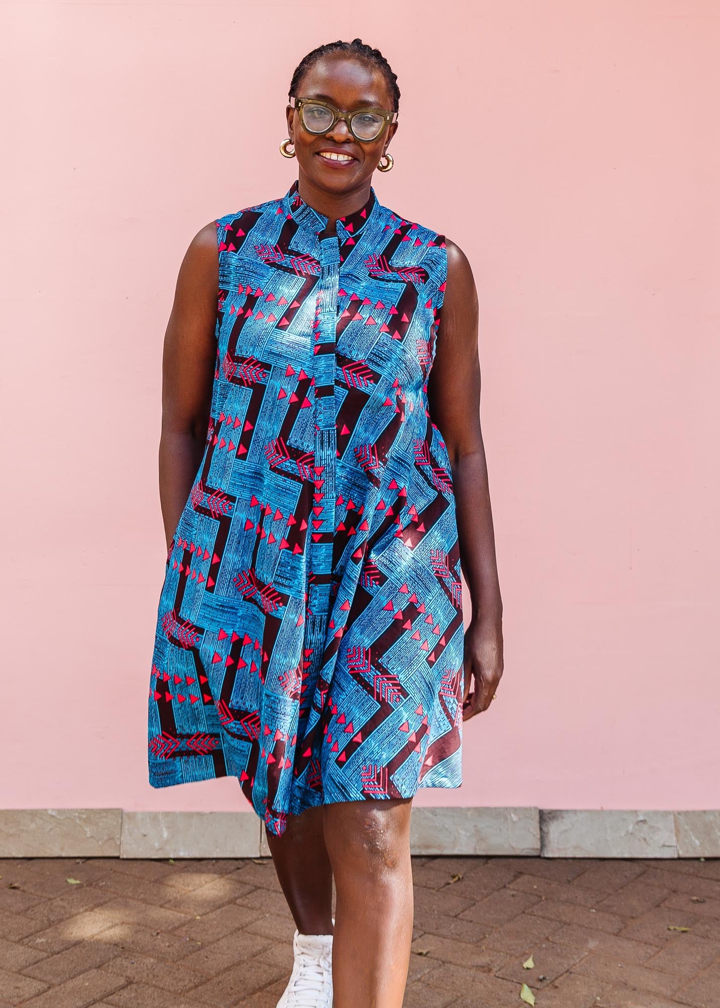 The model is wearing black, blue and hot pink geometric print dress