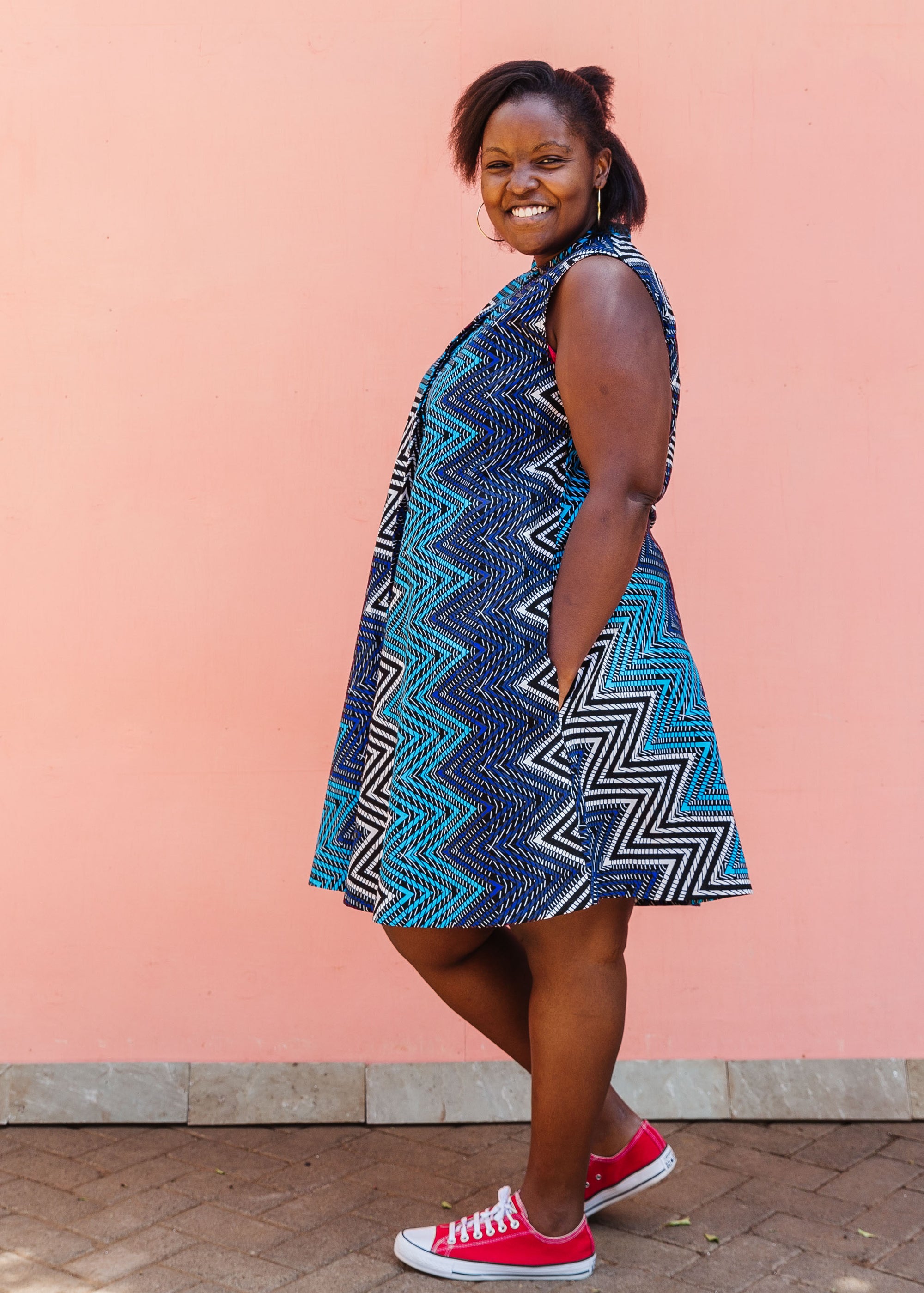 Model wearing blue, aqua and white zig zag print dress.