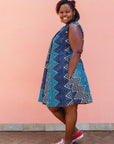 Model wearing blue, aqua and white zig zag print dress.